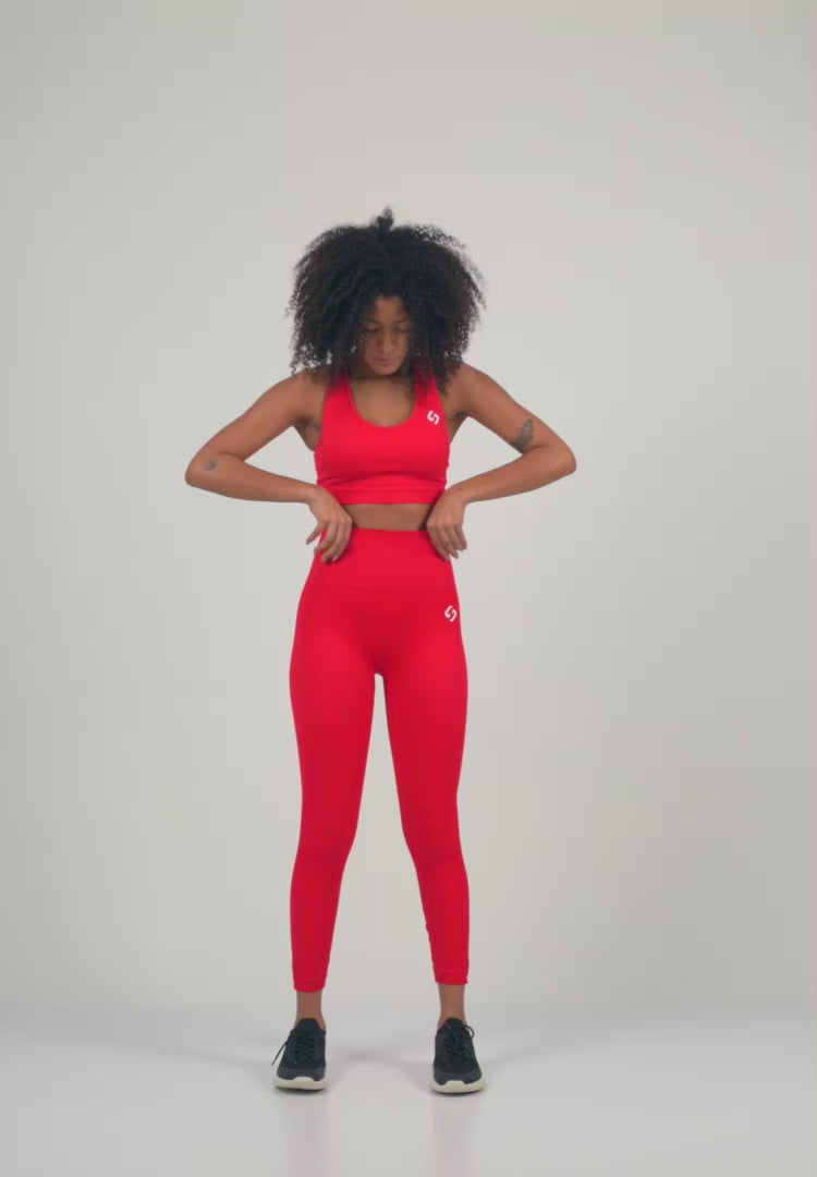 Color_Bright Red | A Woman Wearing Bright Red Color Seamless High-Waist Ankle-Length Ribbed Leggings. Super-Soft