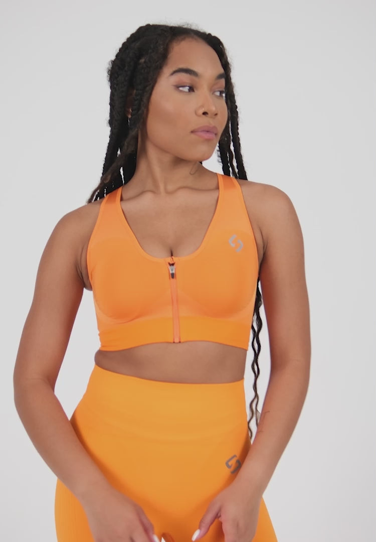 Farbe_Orange | A Woman Wearing Orange Color High Impact Sports Bra