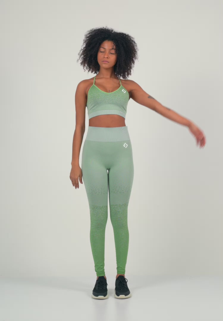 A Woman Wearing Mist Green Color Seamless Low-Impact Sports Bra with Ombre Effect. Chic Comfort