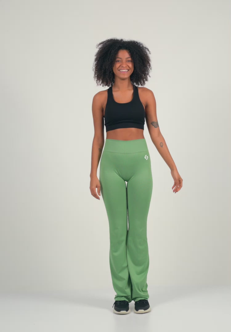 A Woman Wearing Mist Green Color Antigravity Seamless Flare-Leg Yoga Pants. Ultra-Light