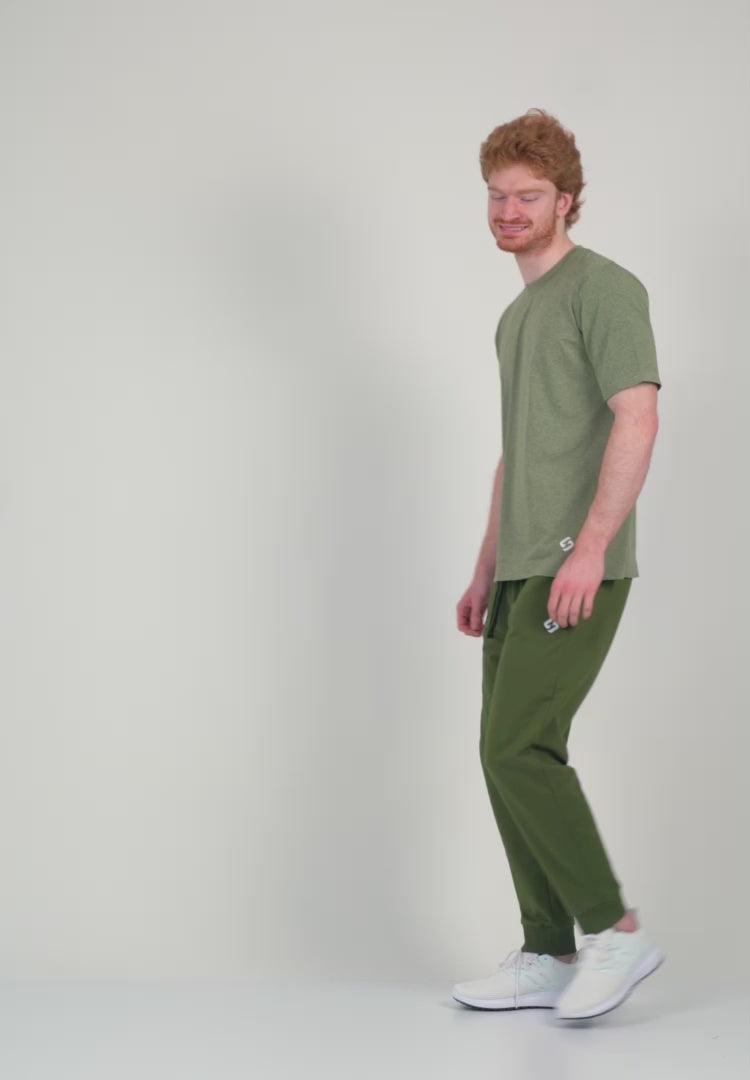 A Man Wearing White Sand Color Unisex Seamless Melange T-Shirt. Enhanced Comfort