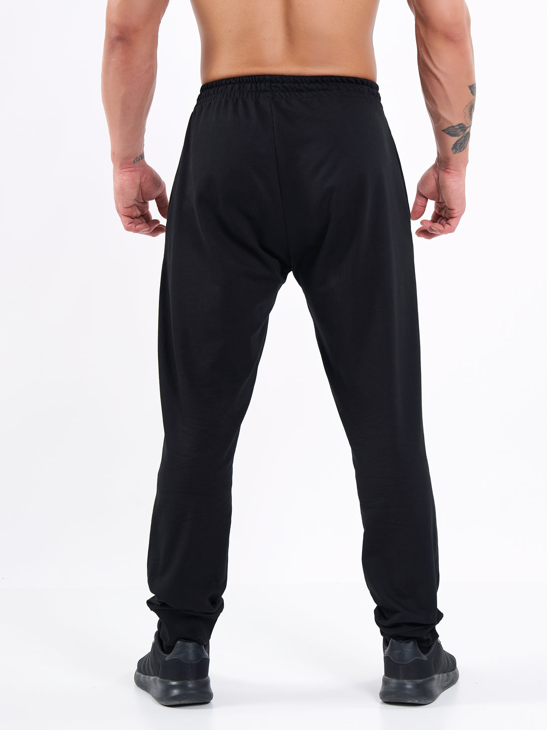 A Man Wearing Deep Black Color Men's Essential Comfort Joggers. Regular Fit