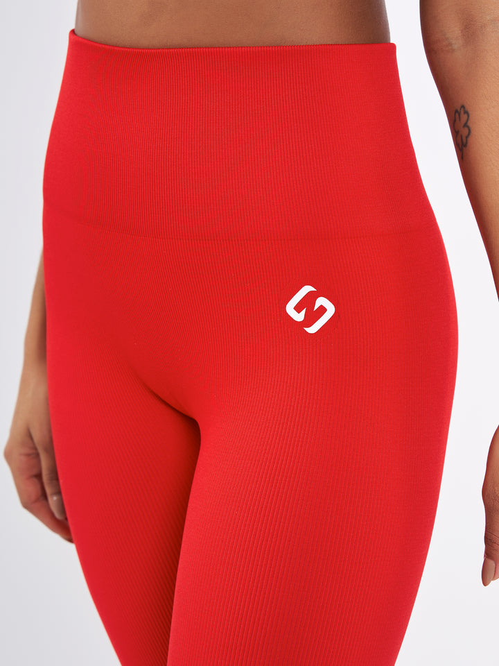 A Woman Wearing Bright Red Color Seamless High-Waist Ankle-Length Ribbed Leggings. Super-Soft