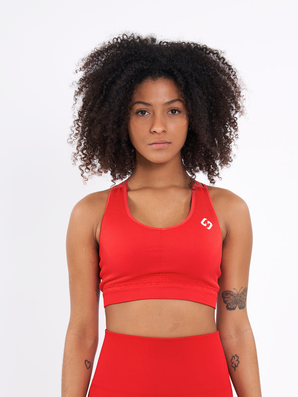Color_Bright Red | A Woman Wearing Bright Red Color Seamless Ribbed Mid-Impact Sports Bra Without Padding Flexible