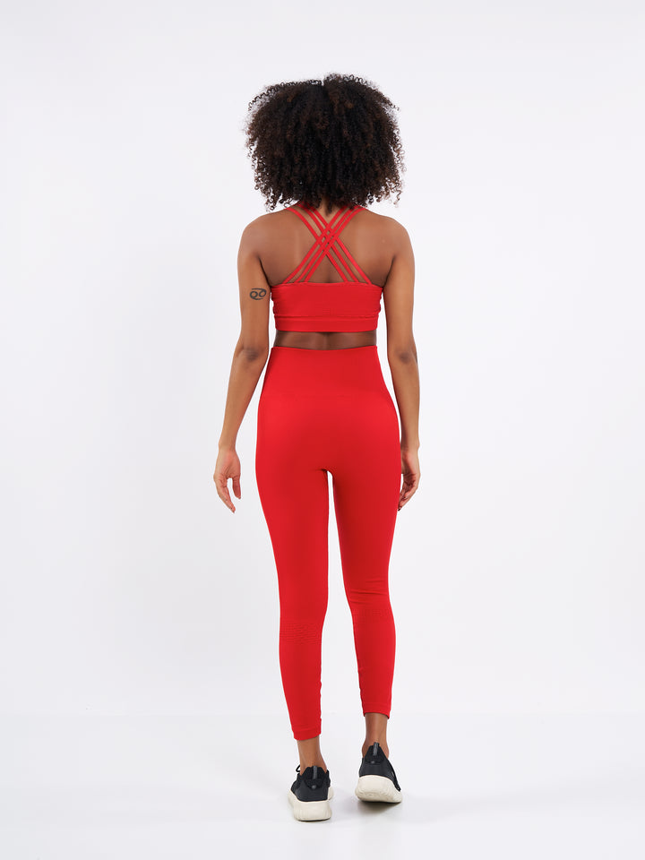 A Woman Wearing Bright Red Color Seamless Ribbed Mid-Impact Sports Bra Without Padding Flexible