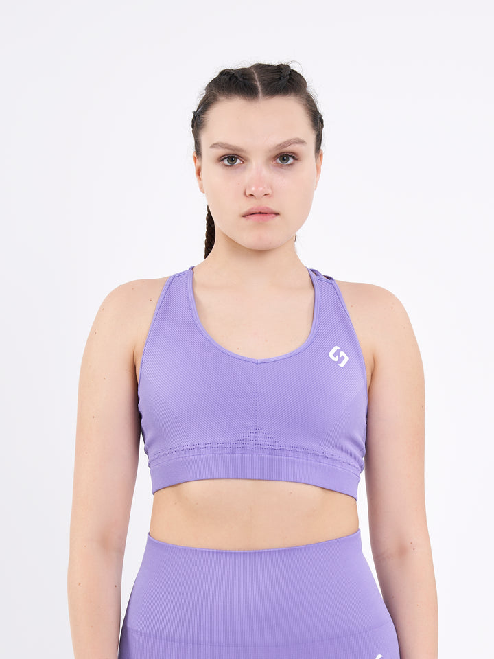 A Woman Wearing Lavender Fields Color Seamless Ribbed Mid-Impact Sports Bra Without Padding Flexible