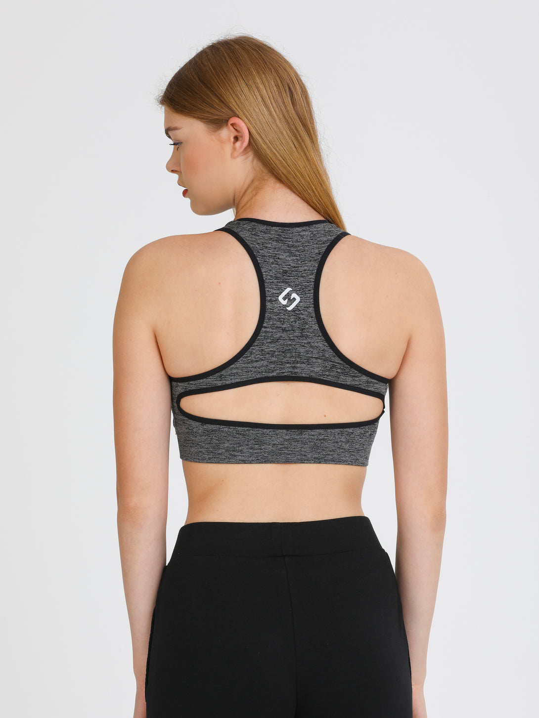 A Woman Wearing Black Color Seamless Medium Support Sports Bra