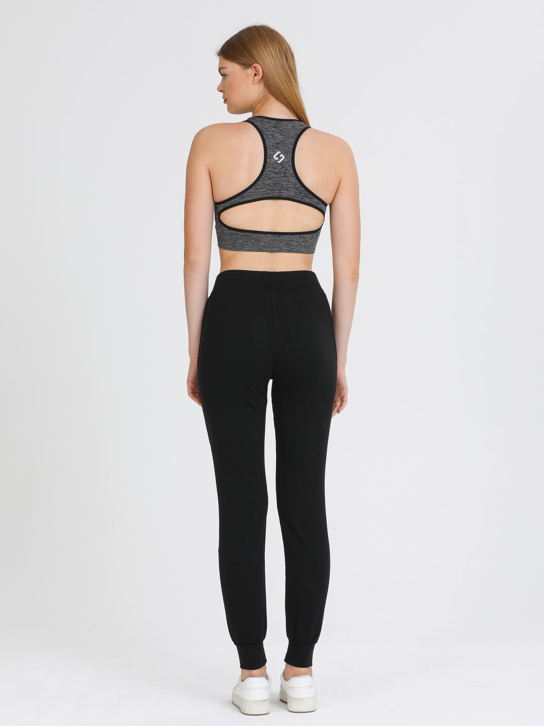 A Woman Wearing Black Color Seamless Medium Support Sports Bra