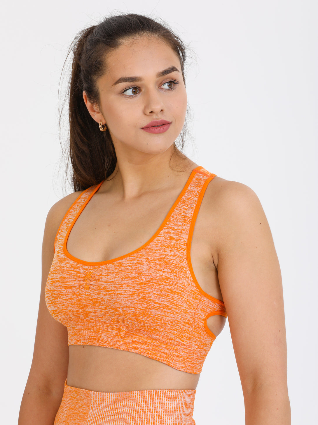 A Woman Wearing Orange Color Seamless Medium Support Sports Bra