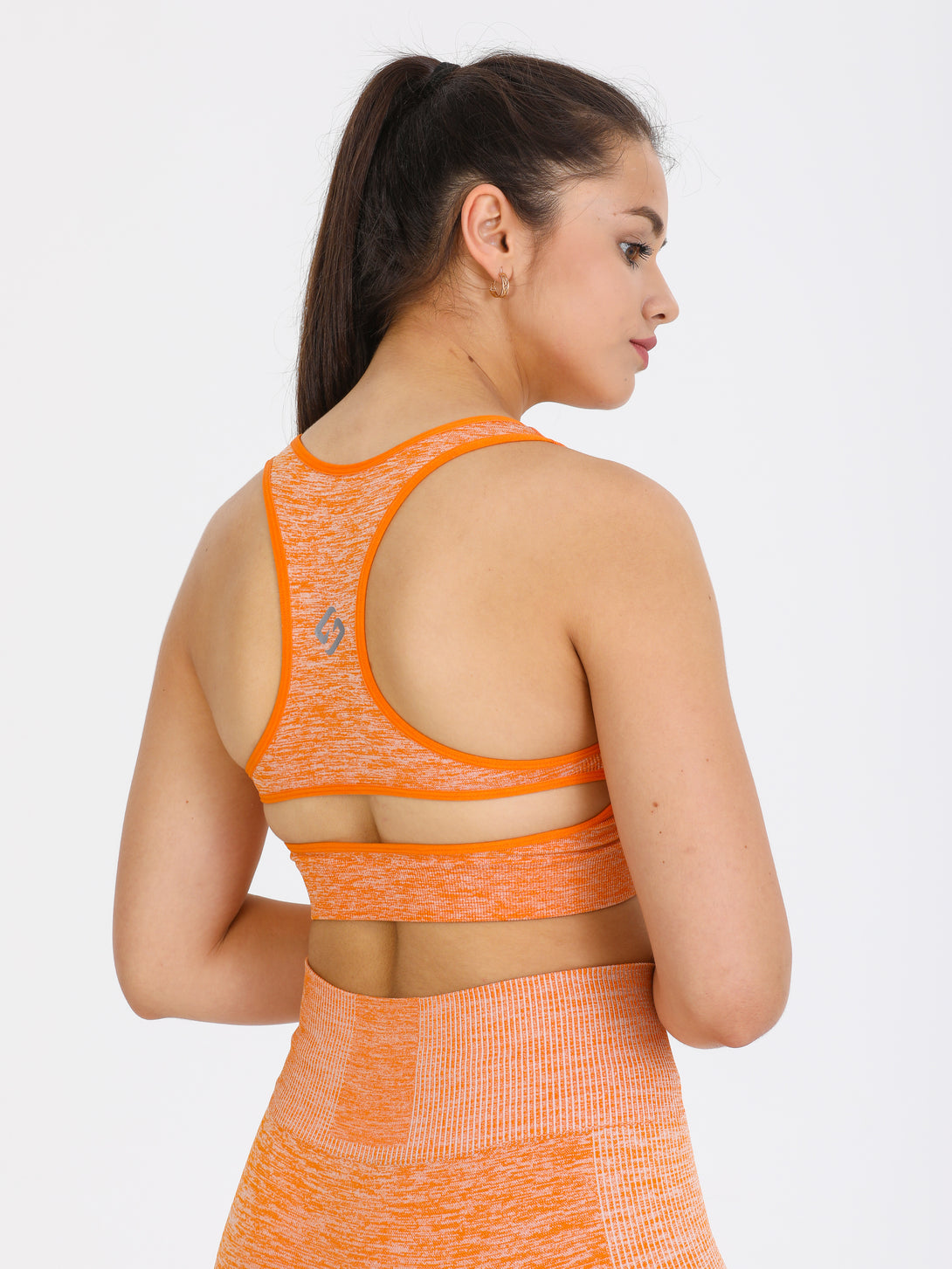 A Woman Wearing Orange Color Seamless Medium Support Sports Bra
