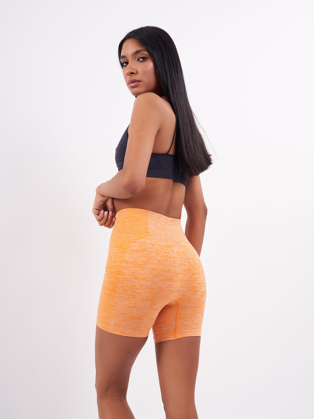 A Woman Wearing Orange Color Seamless Melange Shorts