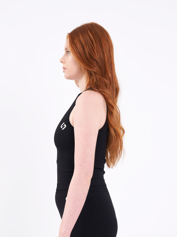 A Women Wearing Deep Black Color Zen Confidence Seamless Compressive Crop Top. Sculpted Silhouette