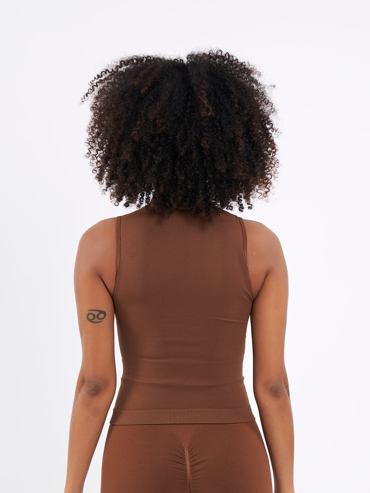 A Women Wearing Toffee Color Zen Confidence Seamless Compressive Crop Top. Sculpted Silhouette