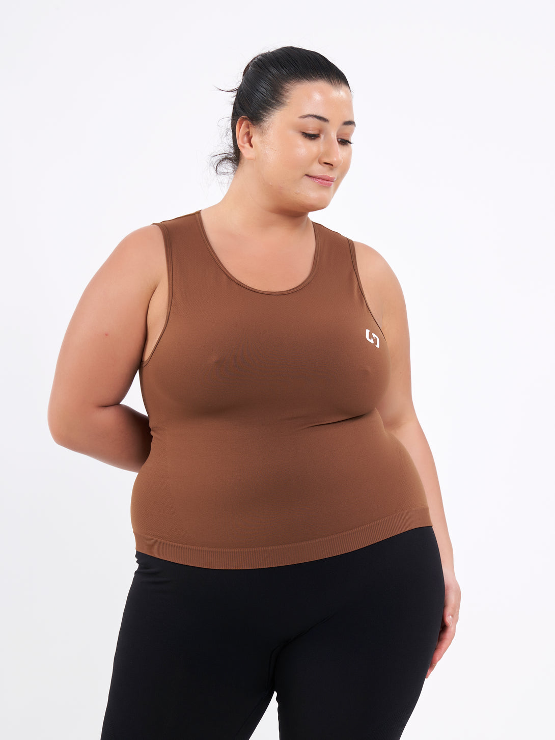 A Women Wearing Toffe Brown Color Zen Confidence Seamless Compressive Crop Top. Sculpted Silhouette