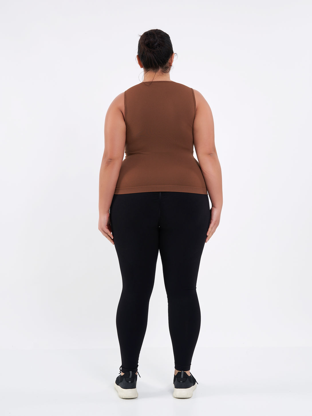A Women Wearing Toffe Brown Color Zen Confidence Seamless Compressive Crop Top. Sculpted Silhouette