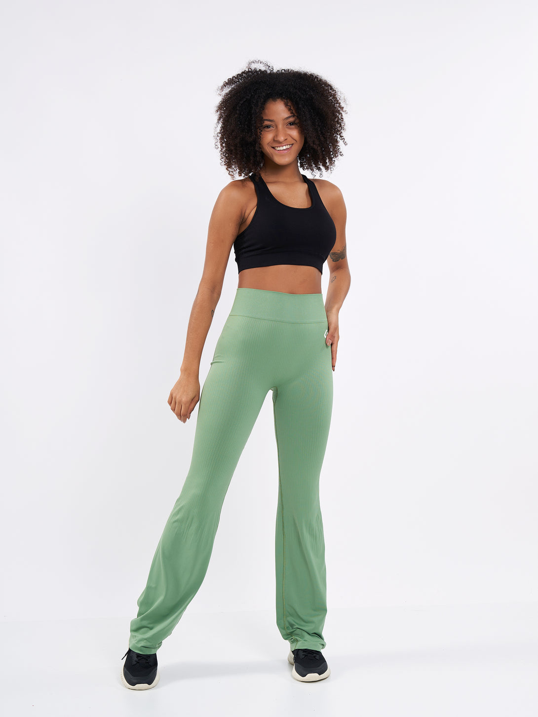 A Woman Wearing Mist Green Color Antigravity Seamless Flare-Leg Yoga Pants. Ultra-Light