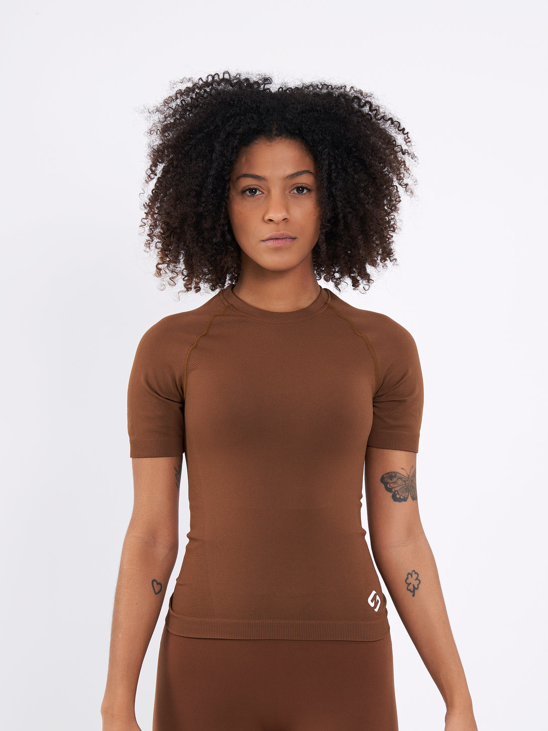 A Women Wearing Toffe Brown Color Zen Confidence Seamless Compressive T-Shirt. Sculpted Silhouette