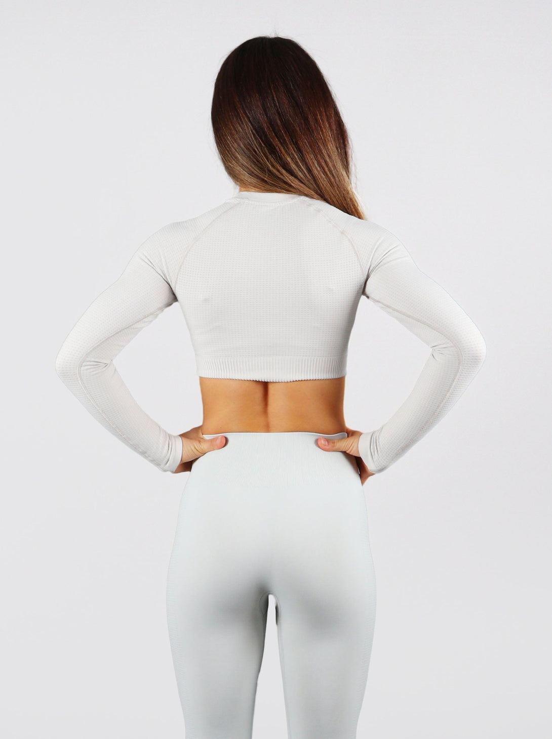 A Woman Wearing Light Grey Color The Main Long Sleeve Crop Top