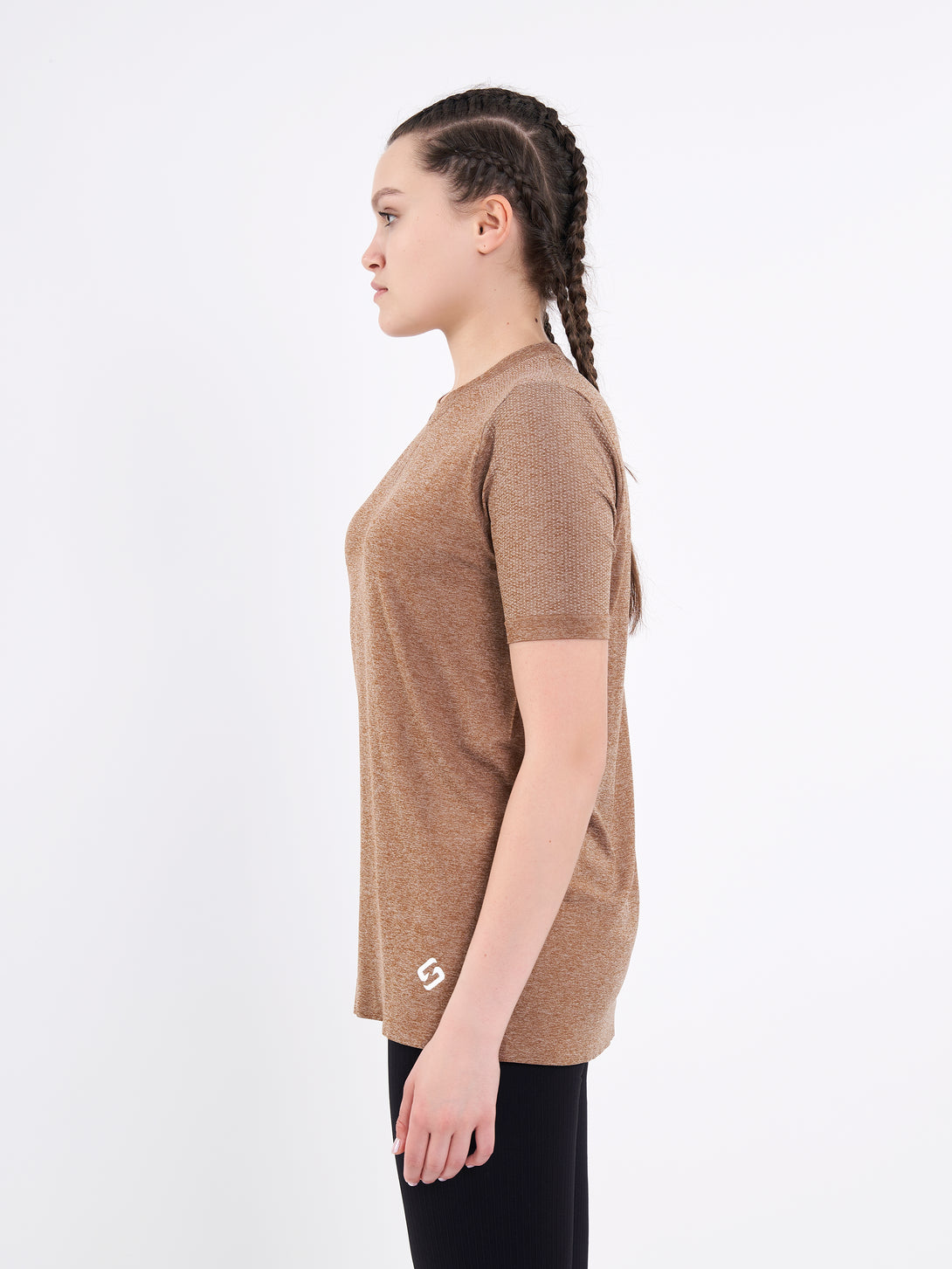 A Woman Wearing Toffe Brown Color Unisex Seamless Melange T-Shirt. Enhanced Comfort