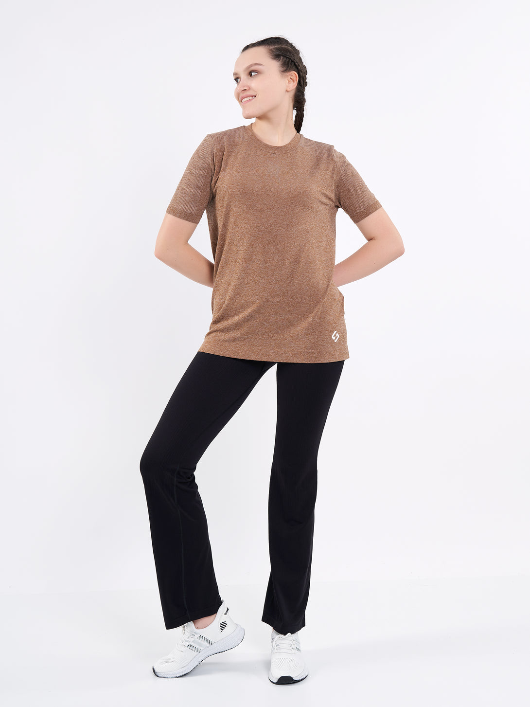 A Woman Wearing Toffe Brown Color Unisex Seamless Melange T-Shirt. Enhanced Comfort
