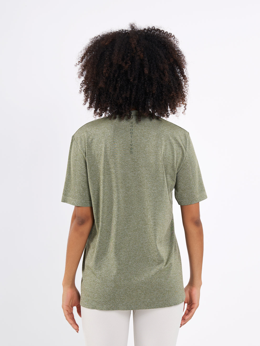 A Woman Wearing Zen Khaki Color Unisex Seamless Melange T-Shirt. Enhanced Comfort