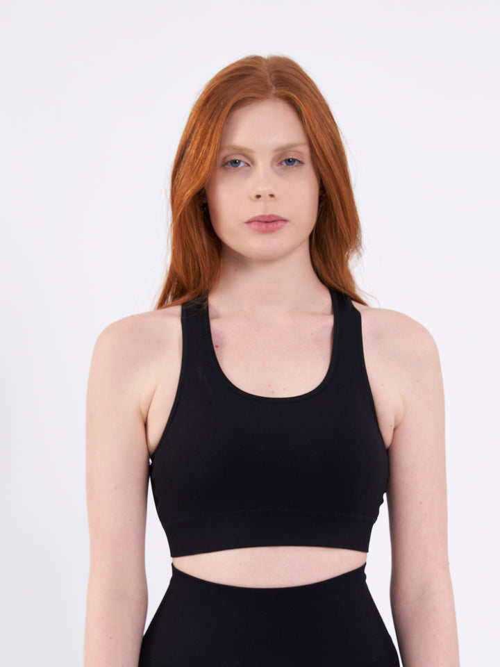 A Woman Wearing Deep Black Color Zen Perfect Seamless Mid-Impact Sports Bra With Padding