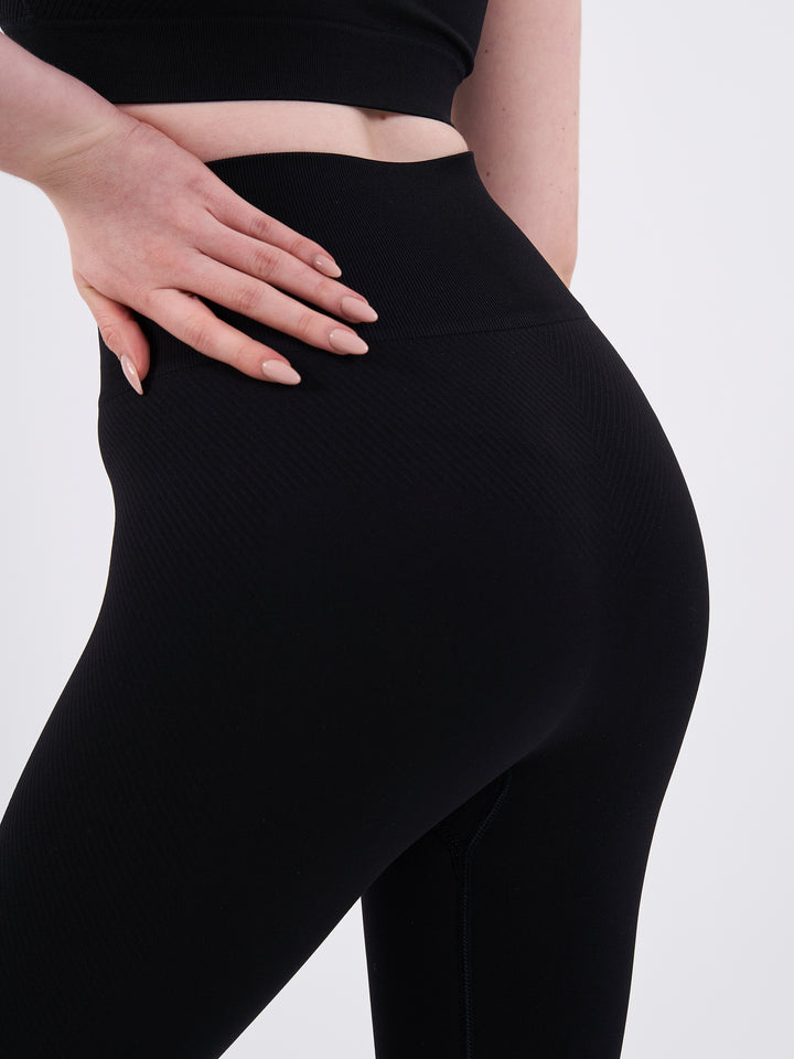 A Woman Wearing Deep Black Color Zen Perfect Seamless High-Waist Crop Leggings. Perfect Fit