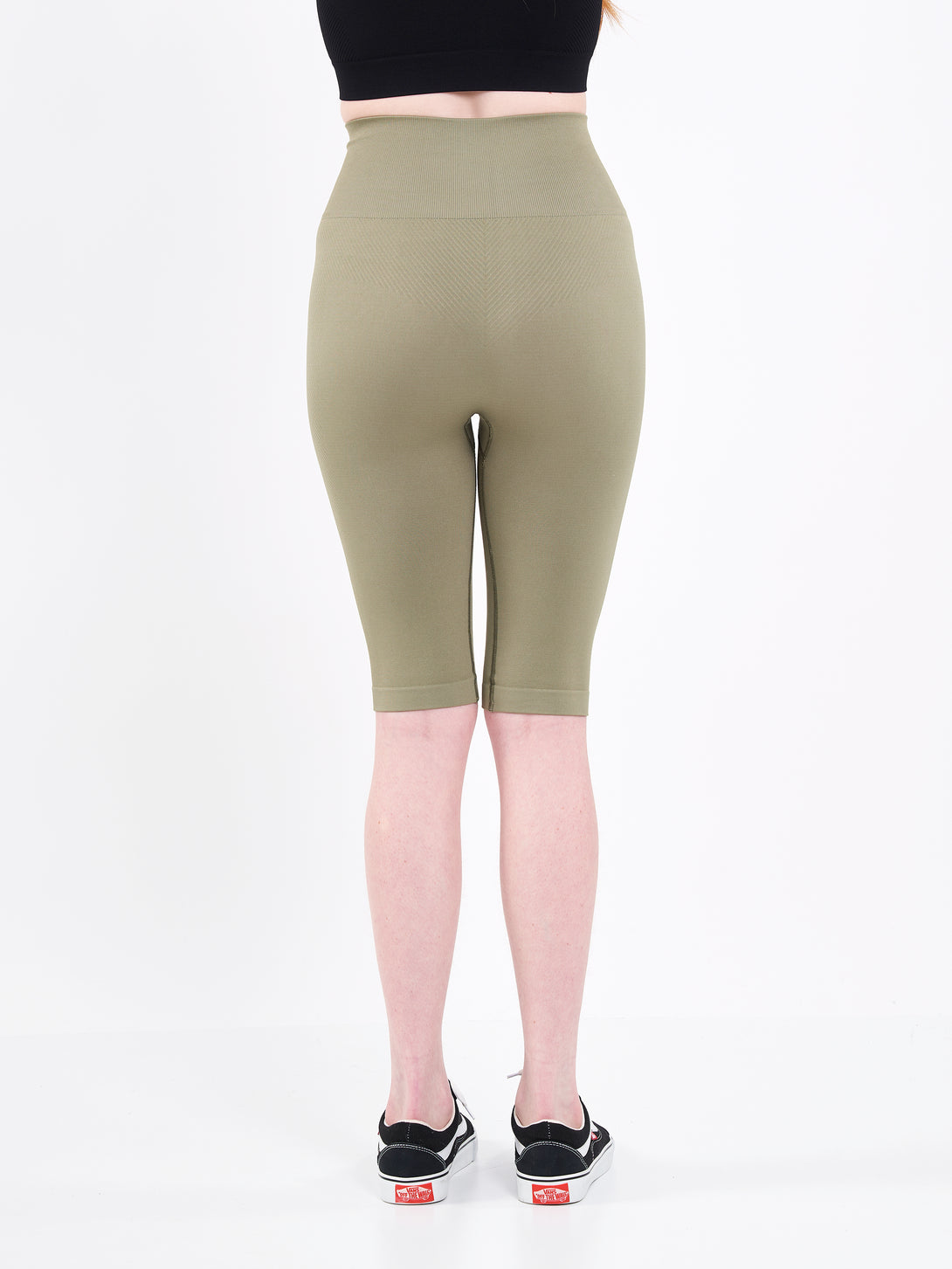 A Woman Wearing Olive Color Zen Perfect Seamless High-Waist Longline Shorts. Perfect Fit