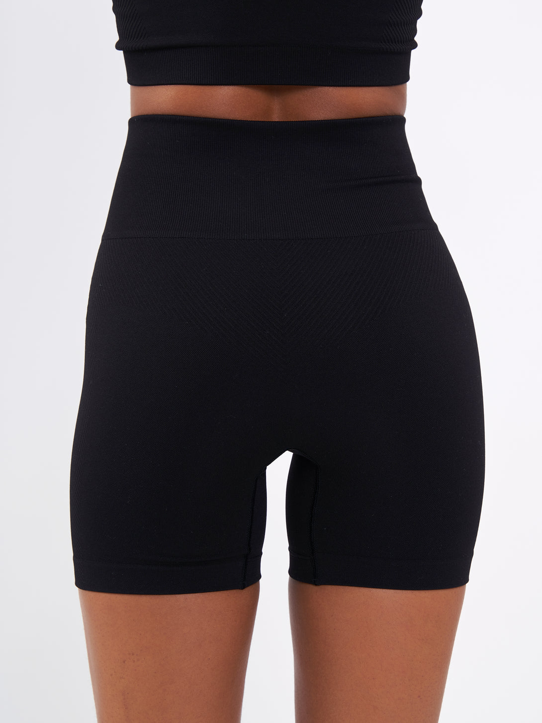 A Woman Wearing Deep Black Color Zen Perfect Seamless High-Waist Shorts. Perfect Fit