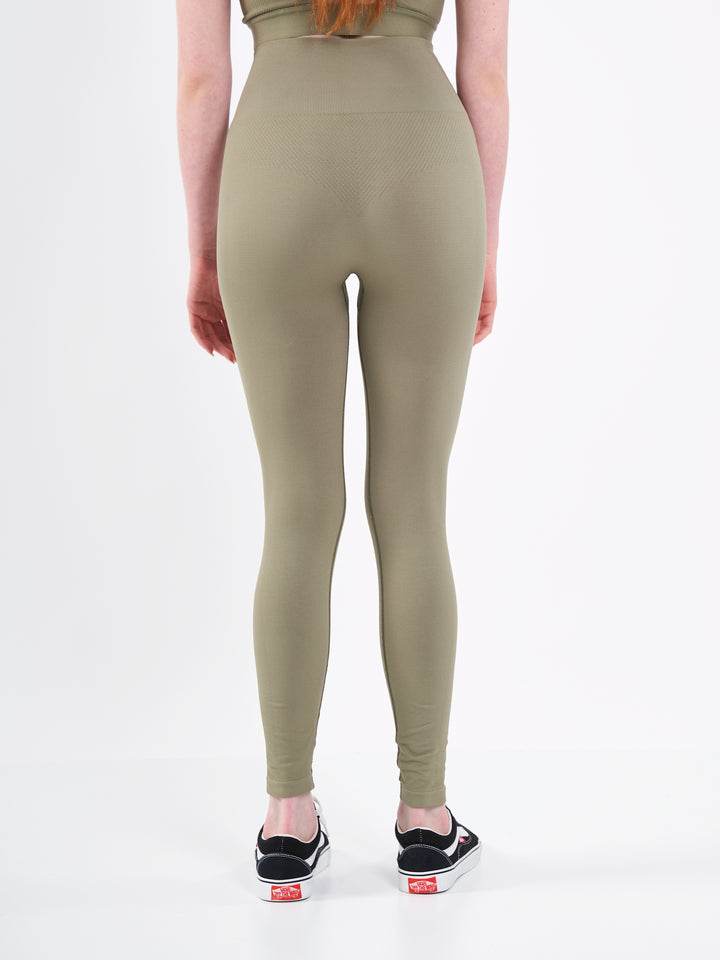A Woman Wearing Olive Color Zen Perfect Seamless High-Waist Ankle-Length Leggings. Perfect Fit
