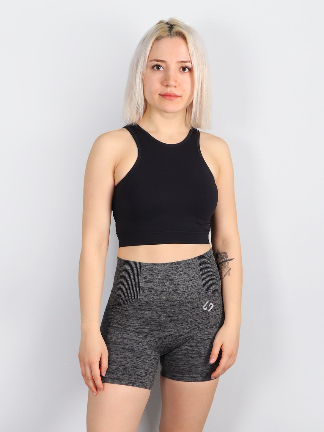 A Woman Wearing Black Color All-Day Seamless Sleeveless Crop Top