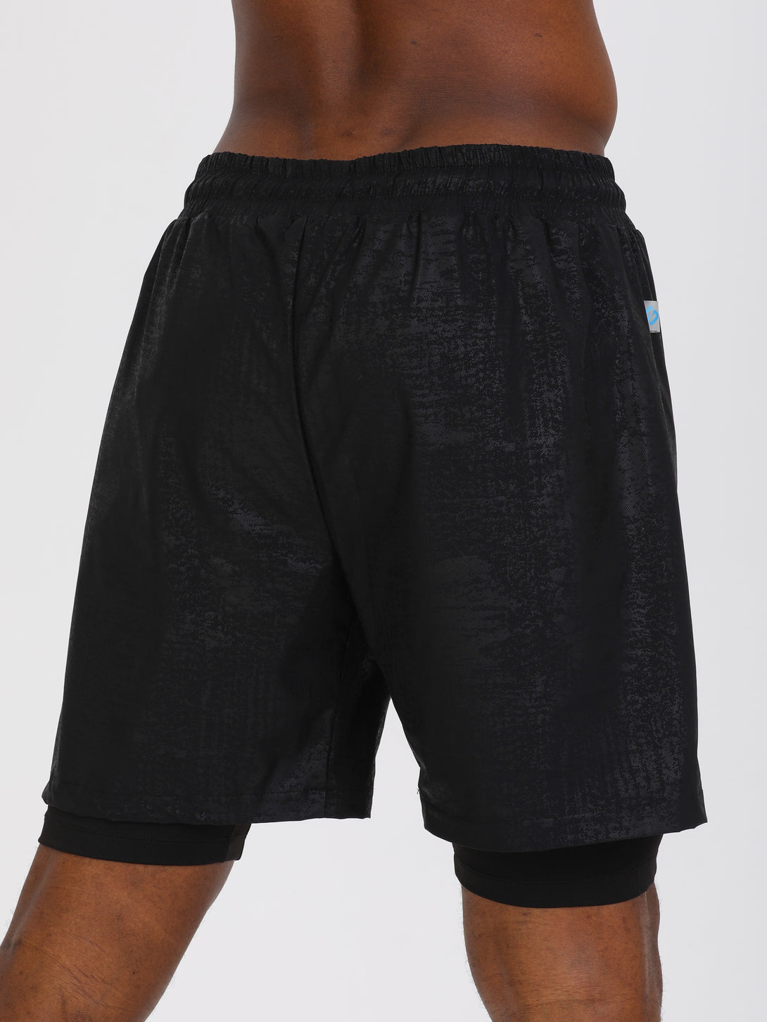 A Man Wearing Black Color Double Layered Mens Shorts