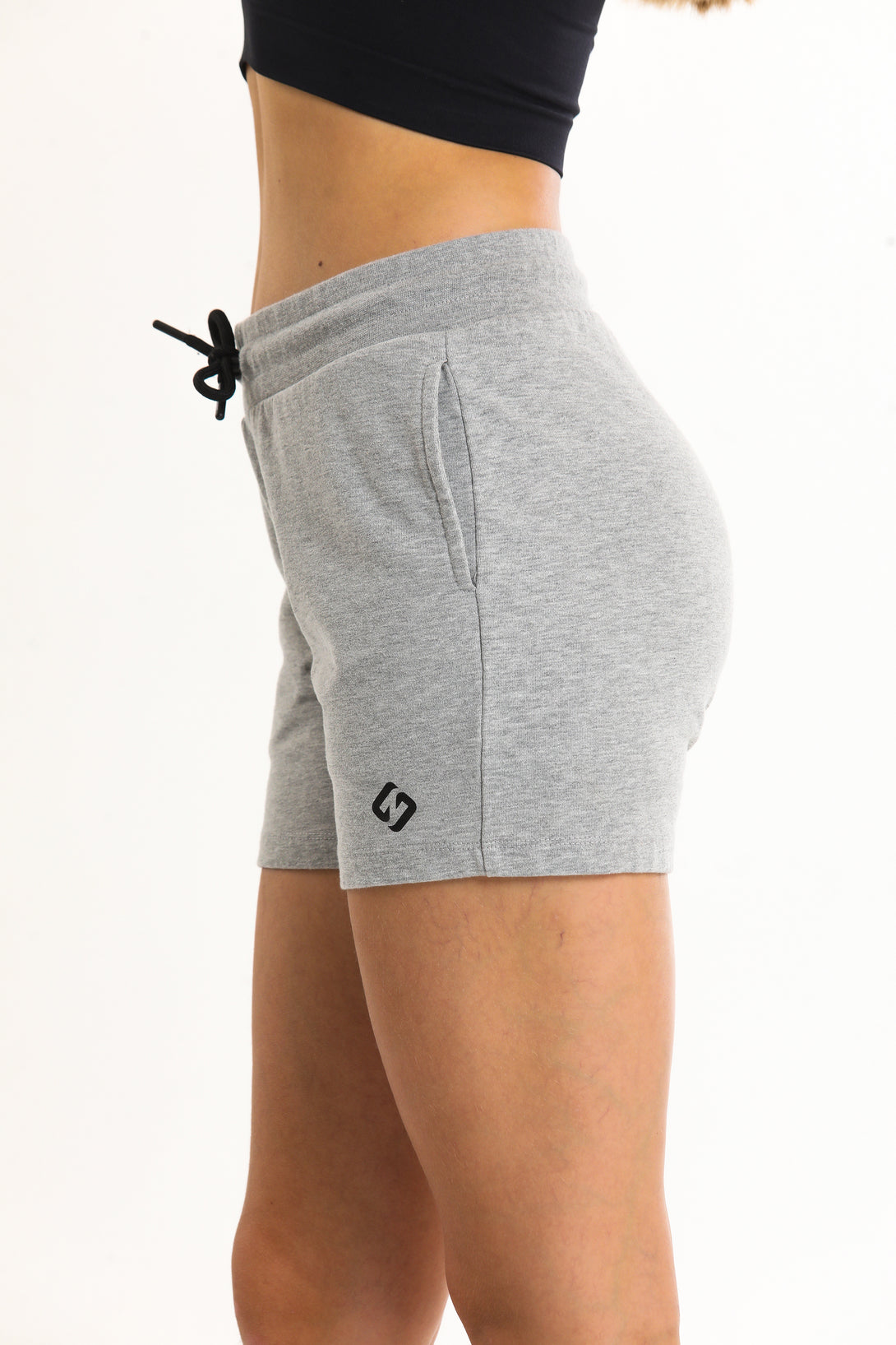 A Woman Wearing Light Grey Melange Color Essential Womens Workout Shorts