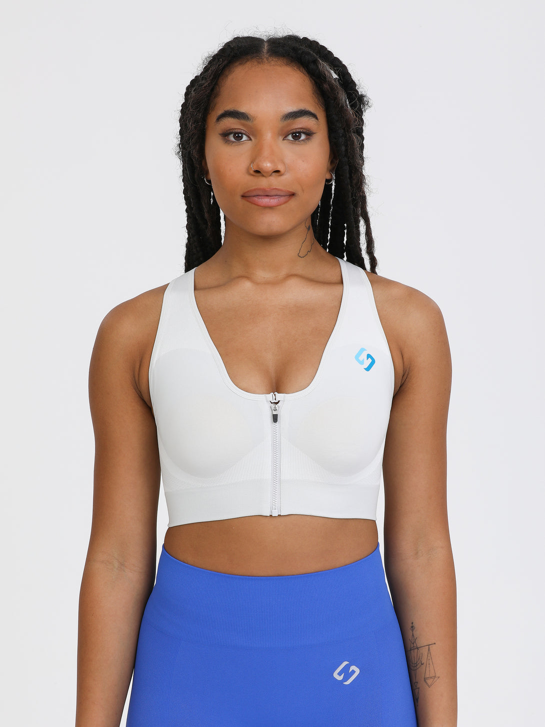 A Woman Wearing Light Grey Color High Impact Sports Bra