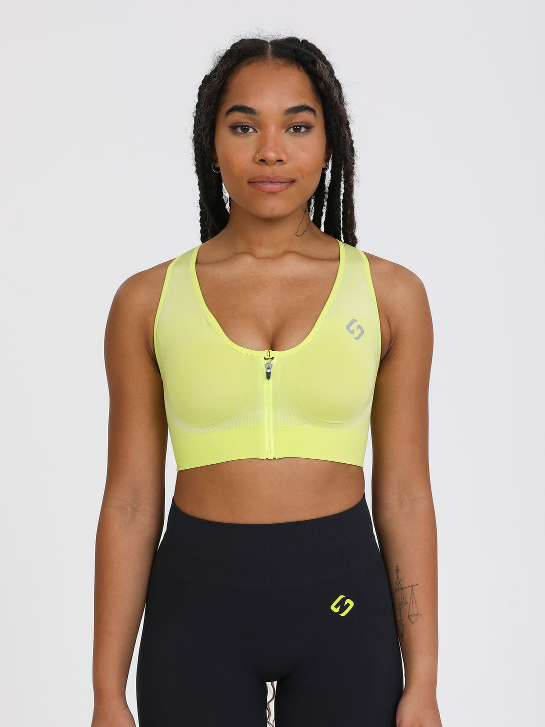 A Woman Wearing Lime Color High Impact Sports Bra