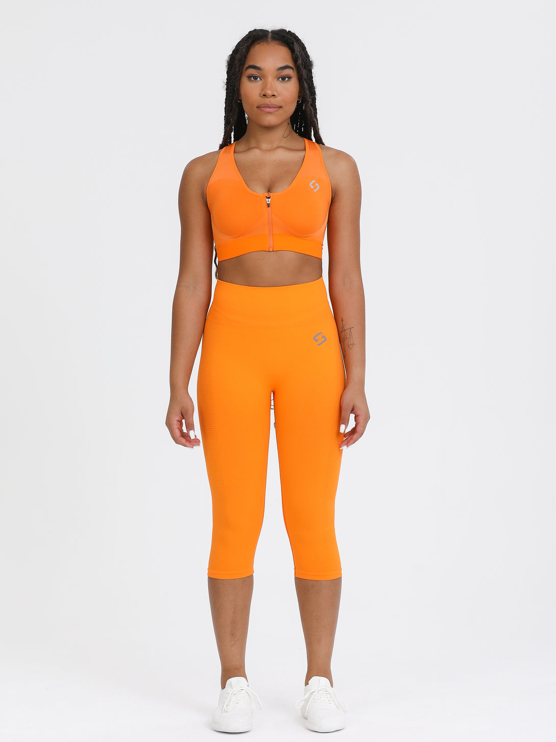 A Woman Wearing Orange Color High Impact Sports Bra