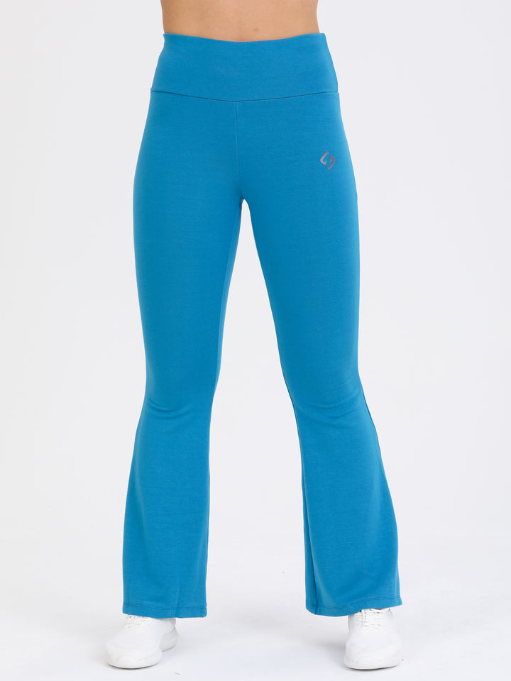 A Woman Wearing Blue Lagoon Color Legacy Jersey Yoga Pants