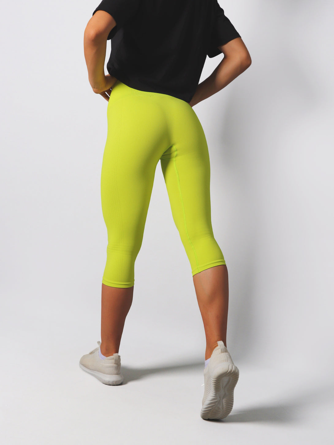 A Woman Wearing Lime Color Seamless Capri Legging