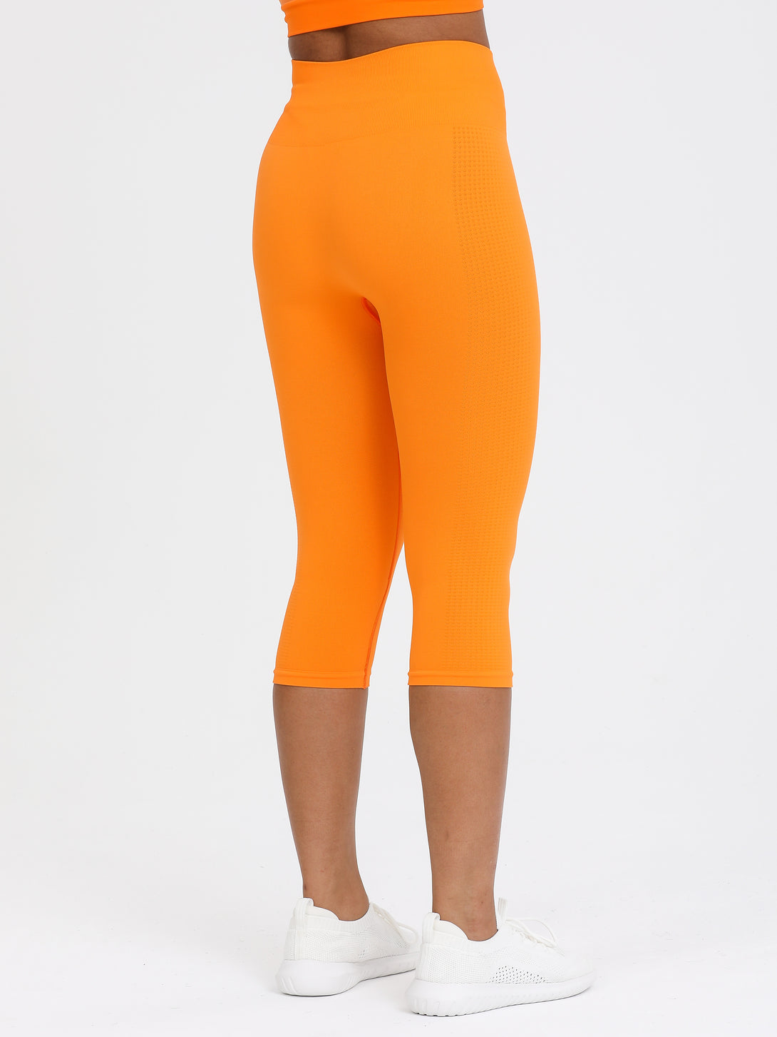 A Woman Wearing Orange Color Seamless Capri Legging