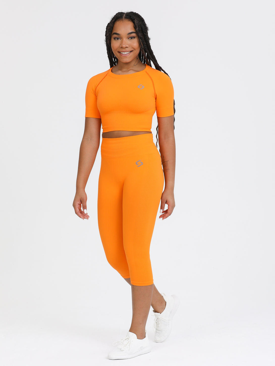 A Woman Wearing Orange Color Seamless Capri Legging
