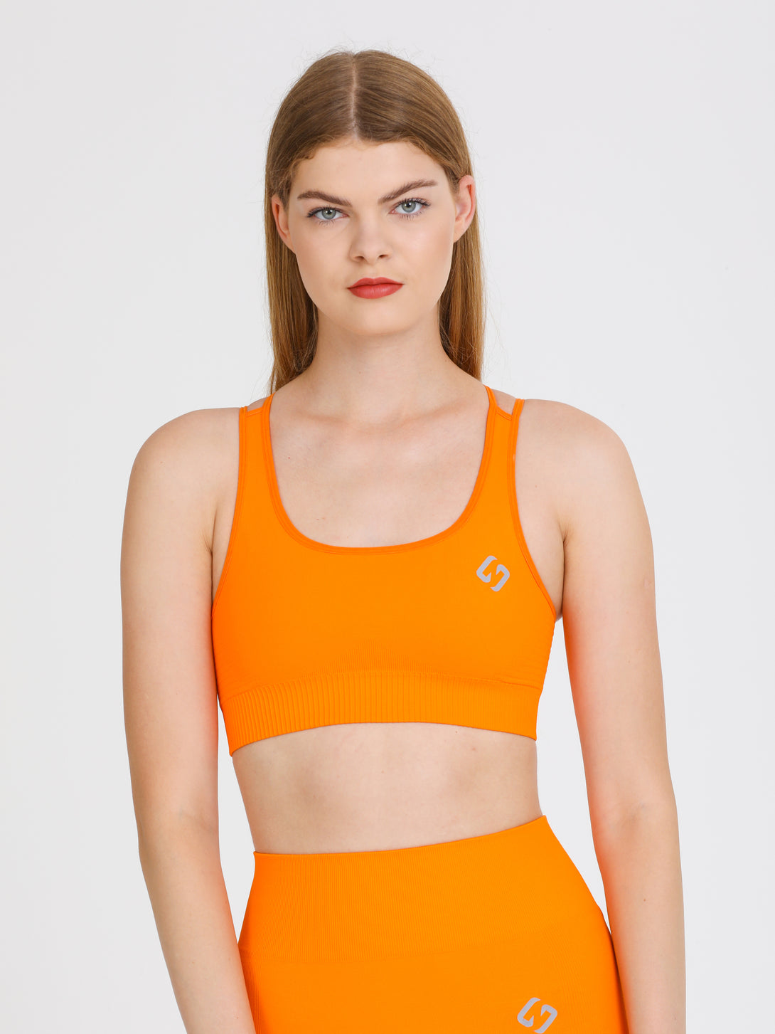 A Woman Wearing Orange Color Seamless Light Support Sports Bra