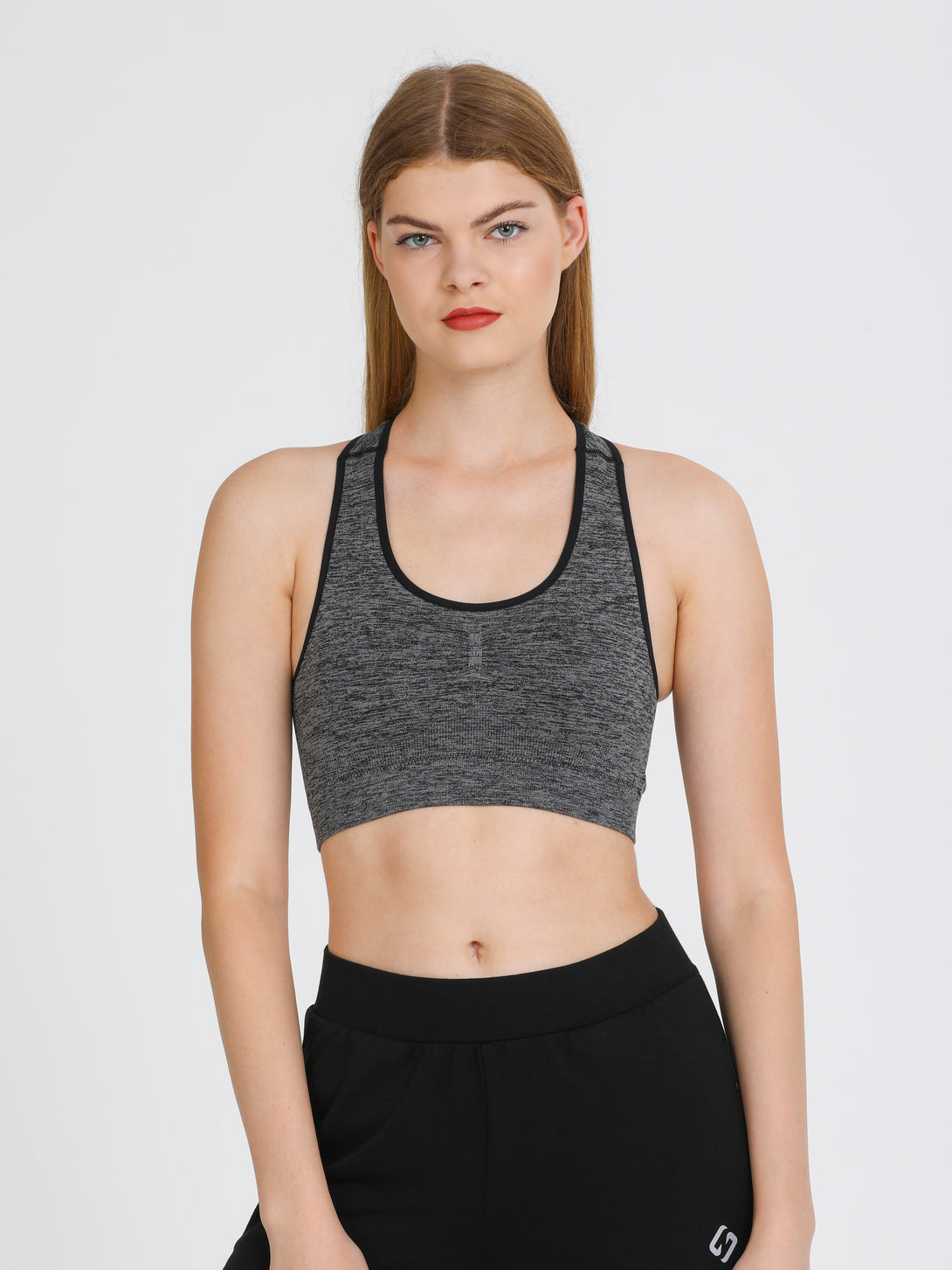 A Woman Wearing Black Color Seamless Medium Support Sports Bra