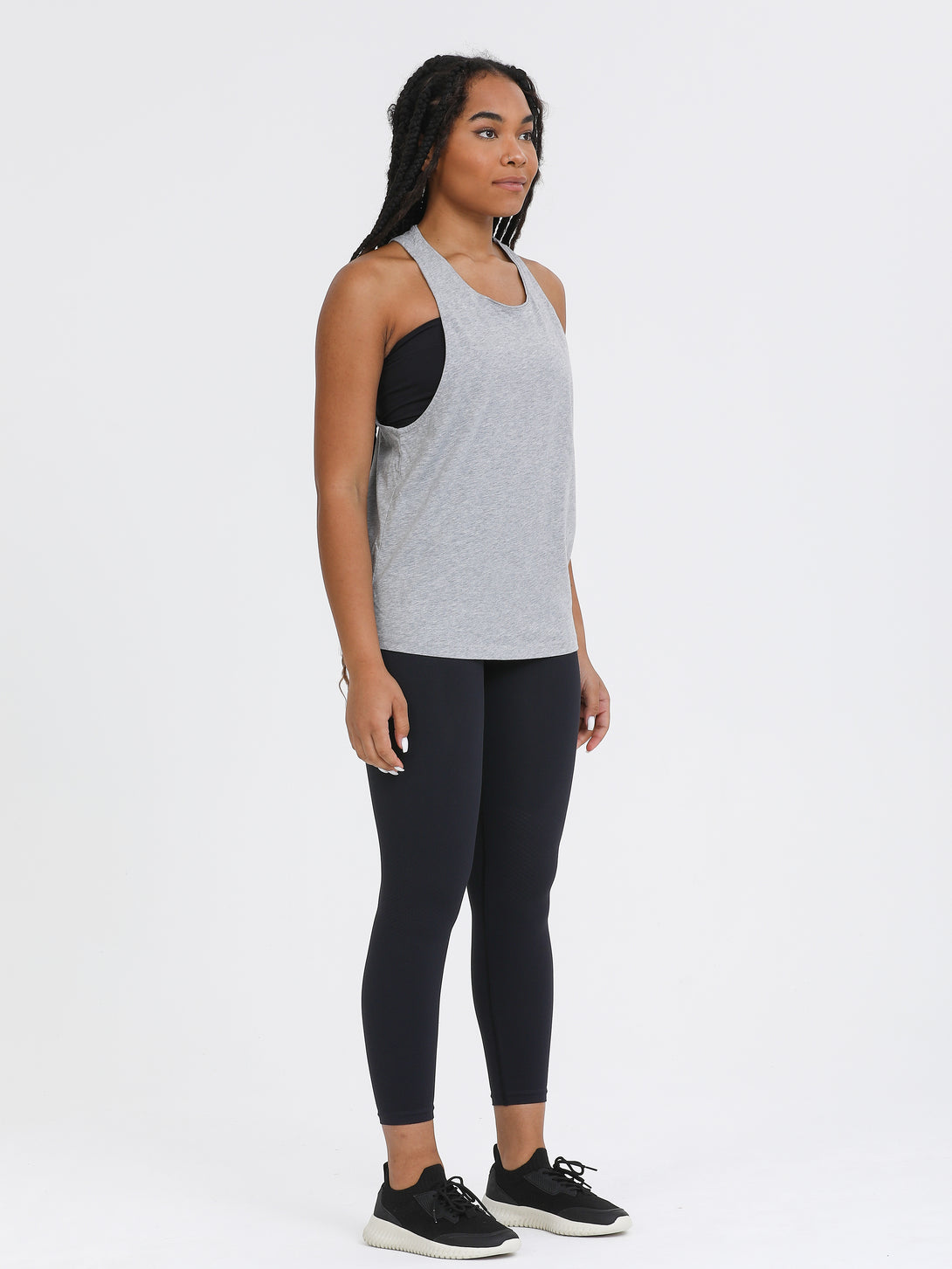 A Woman Wearing Light Grey Melange Color Sporty Jersey Tank Top & Tube Bra Set